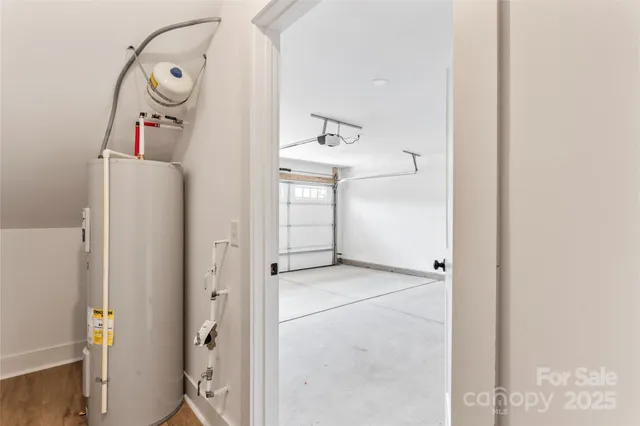 a kitchen with stainless steel appliances a stove a microwave and white cabinets