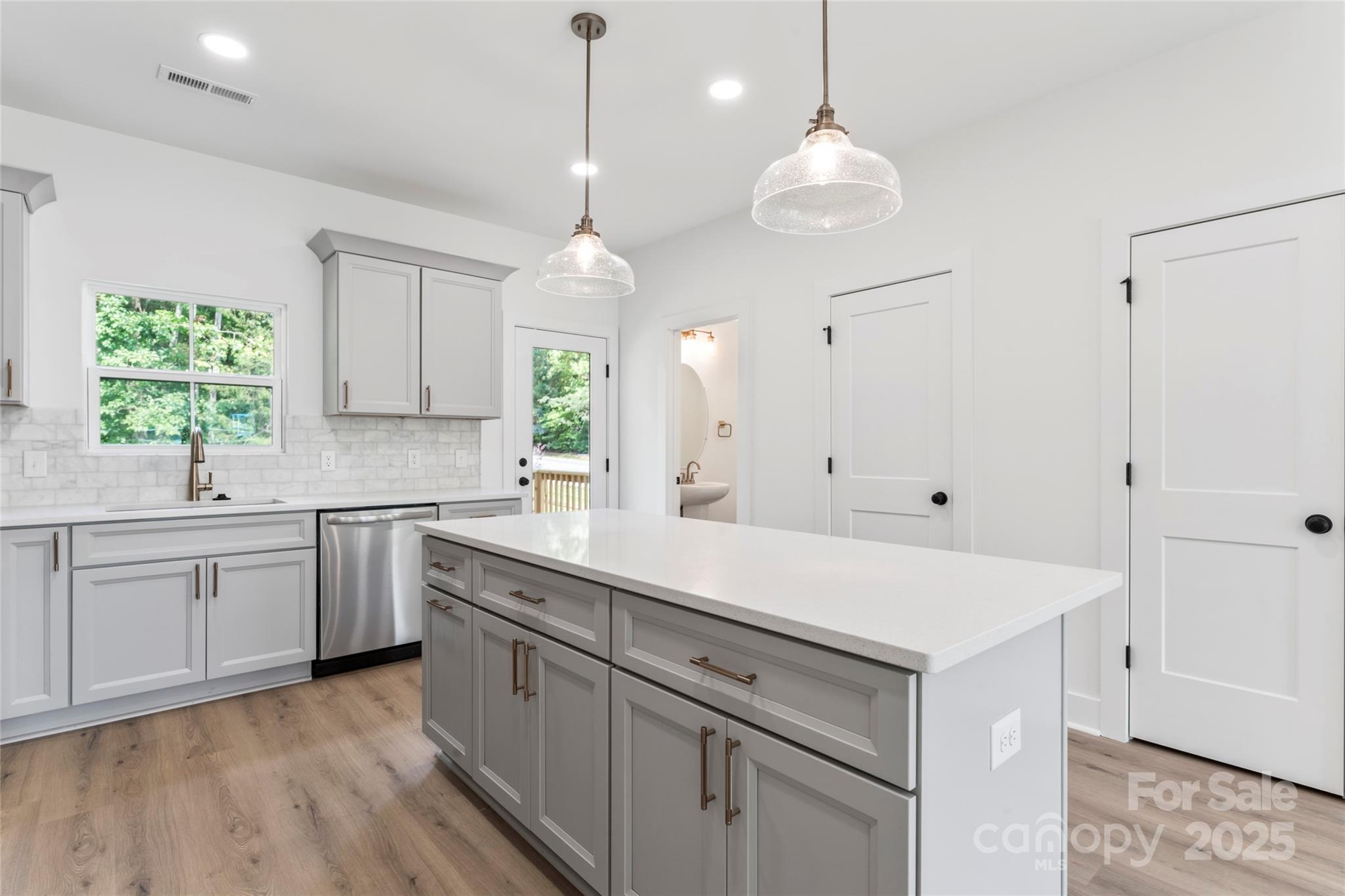 309 Yaupon Court, Unit 17 Fort Mill, SC 29708 - Photo 17 of 43 a kitchen with white cabinets and window