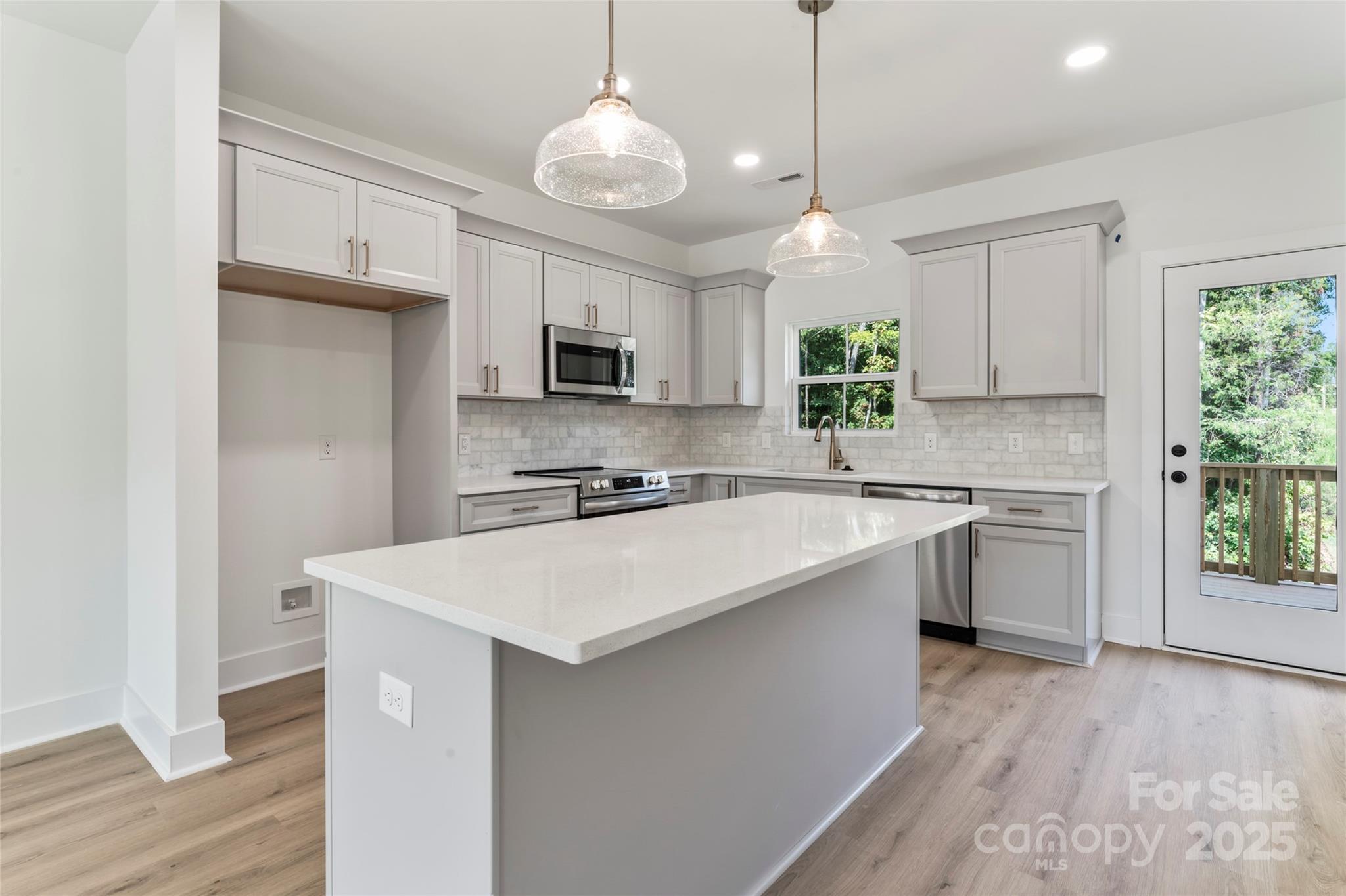 309 Yaupon Court, Unit 17 Fort Mill, SC 29708 - Photo 2 of 43 a kitchen with kitchen island white cabinets and white appliances