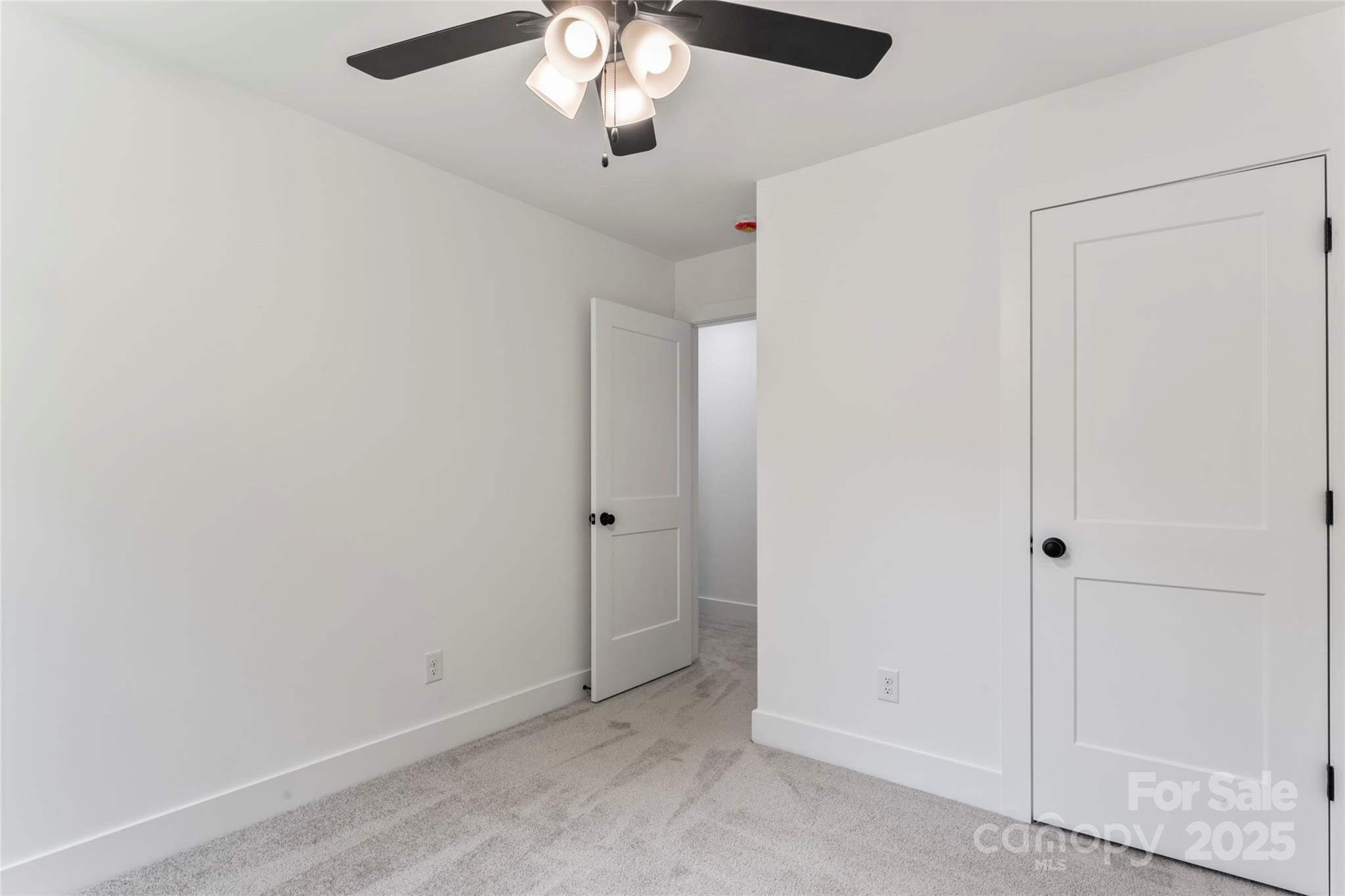 309 Yaupon Court, Unit 17 Fort Mill, SC 29708 - Photo 27 of 43 an empty room with a empty space and a ceiling fan