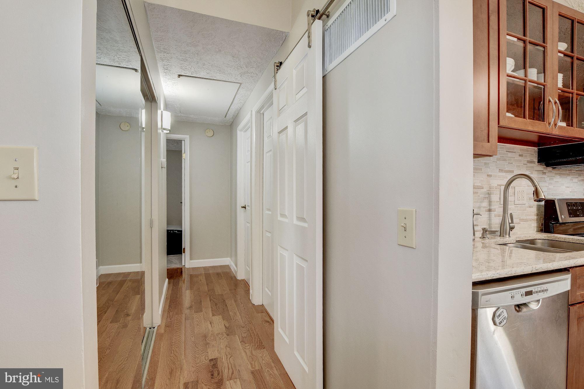 1300 Silo Way Silver Spring, MD 20905 - Photo 10 of 30 Hardwoods in hall, sliding barn door pantry