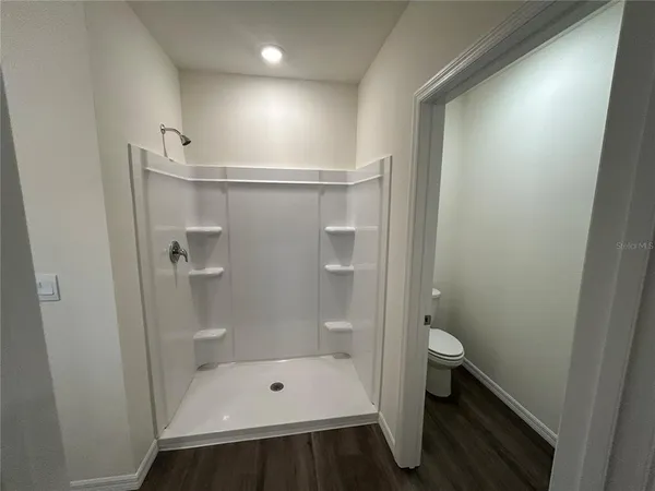 a bathroom with a shower and toilet