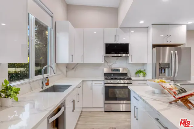 a kitchen with a sink stove and refrigerator
