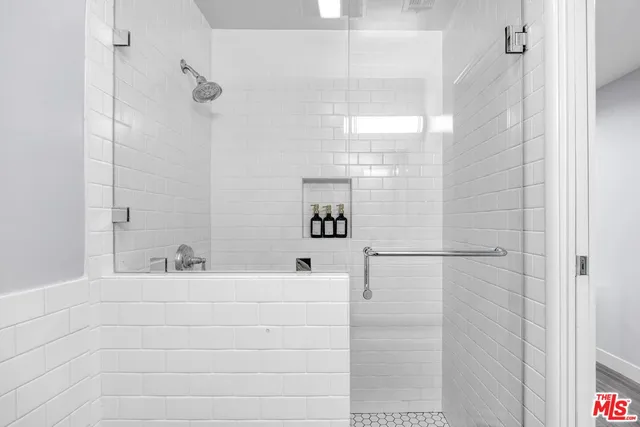 a bathroom with a bathtub and shower