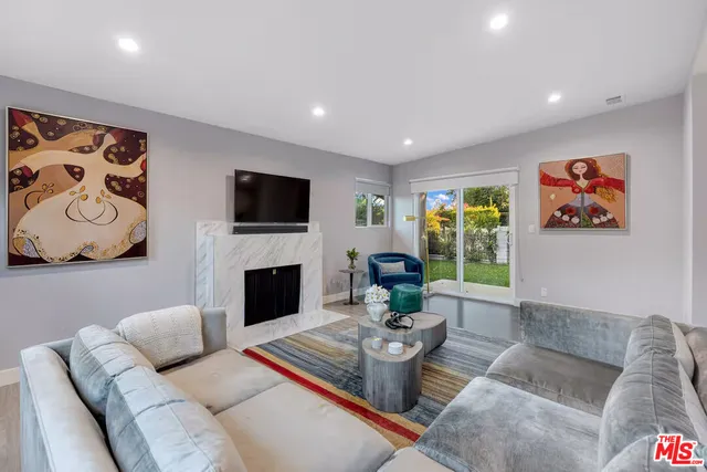 a living room with furniture fireplace and window