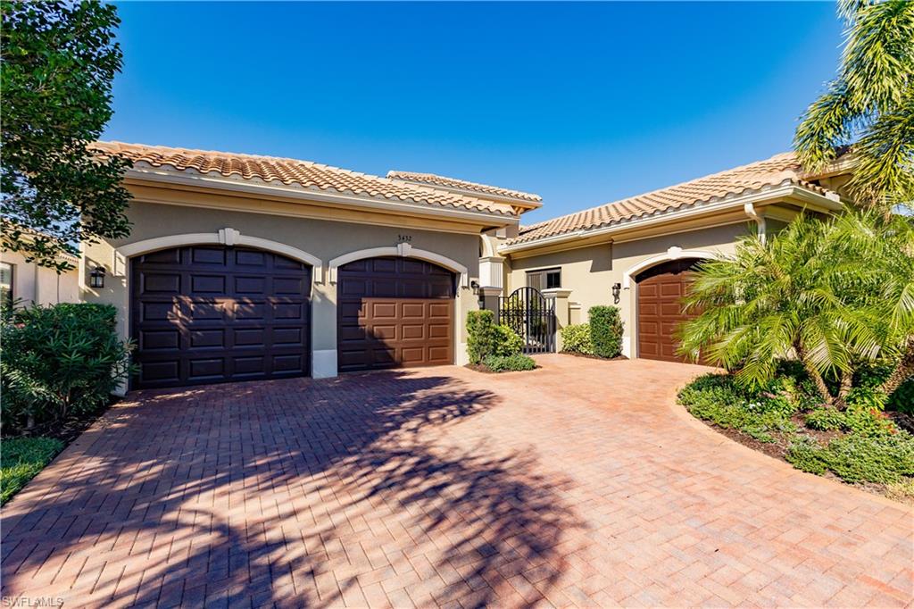 3432 Atlantic Circle Naples, FL 34119 - Photo 1 of 31 a front view of a house with a yard and garage