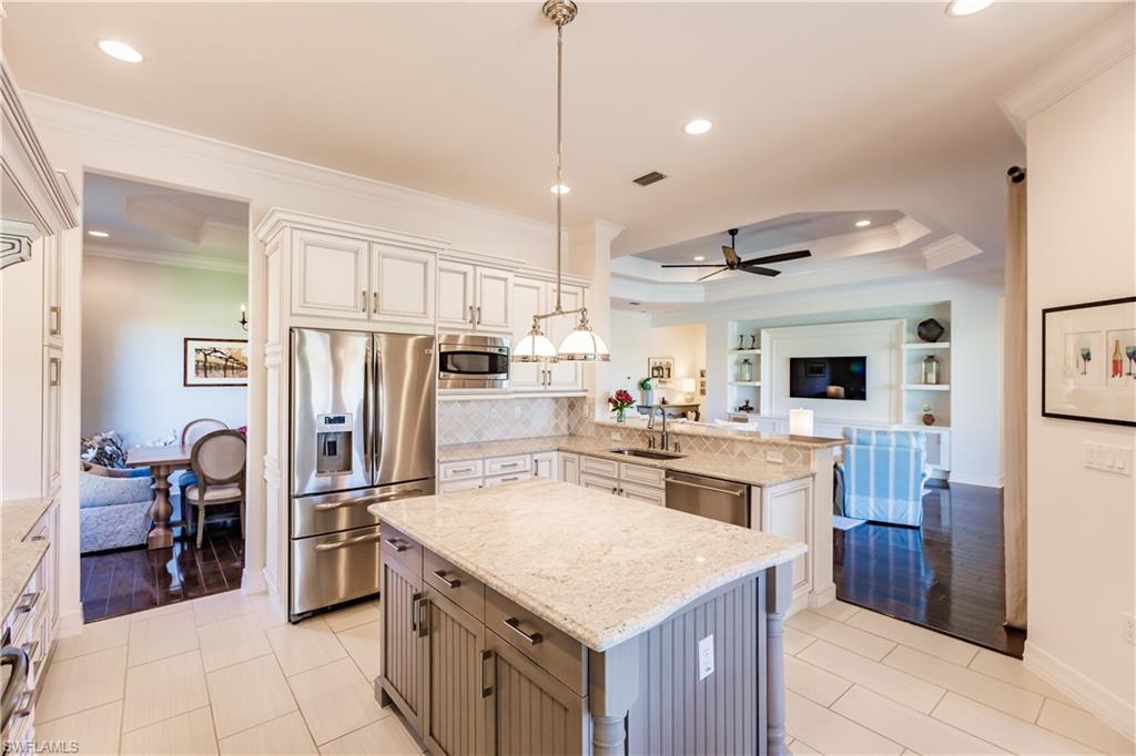 3432 Atlantic Circle Naples, FL 34119 - Photo 13 of 31 a kitchen with a stove a refrigerator and a sink