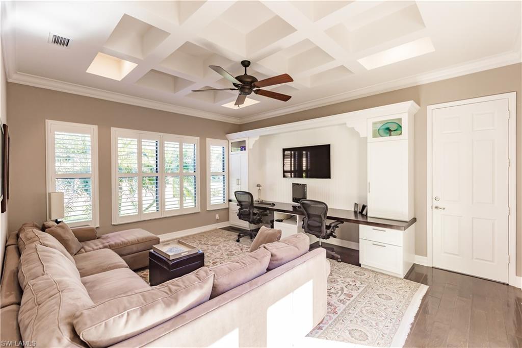3432 Atlantic Circle Naples, FL 34119 - Photo 16 of 31 a living room with furniture flat screen tv and a large window