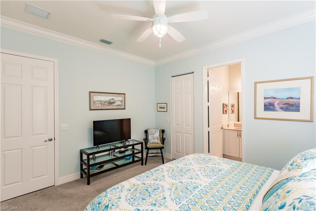 3432 Atlantic Circle Naples, FL 34119 - Photo 18 of 31 a bedroom with a bed and a flat screen tv