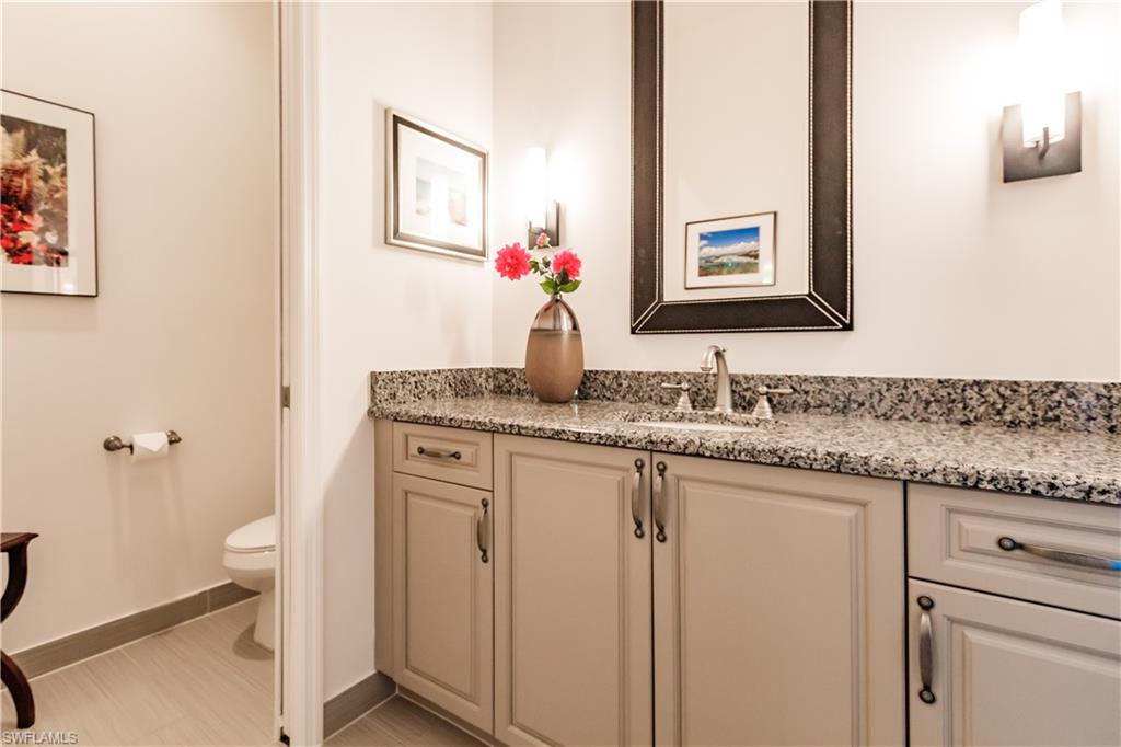 3432 Atlantic Circle Naples, FL 34119 - Photo 19 of 31 a bathroom with a granite countertop sink and a mirror