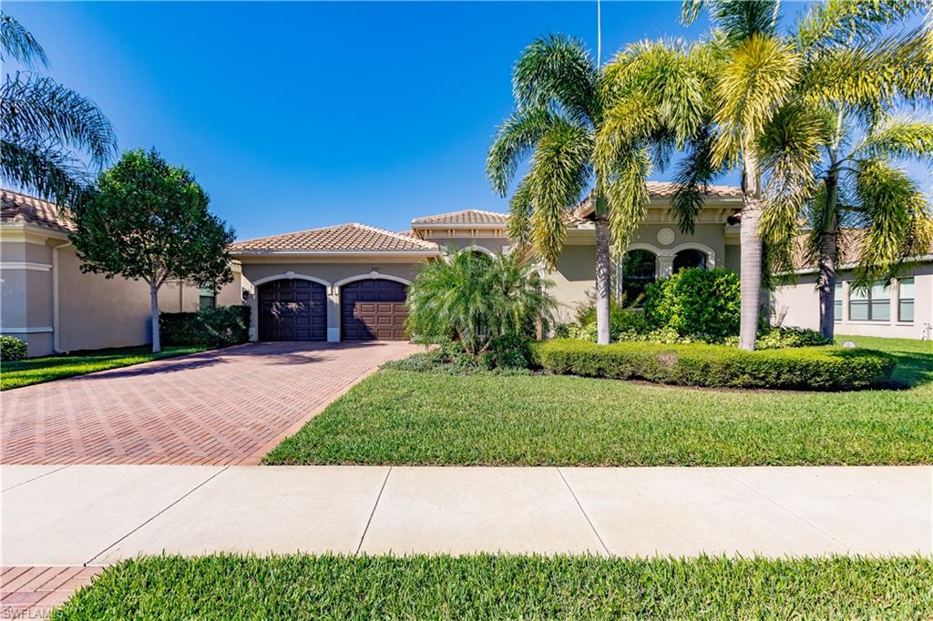 3432 Atlantic Circle Naples, FL 34119 - Photo 2 of 31 a view of house with garden and tall tress