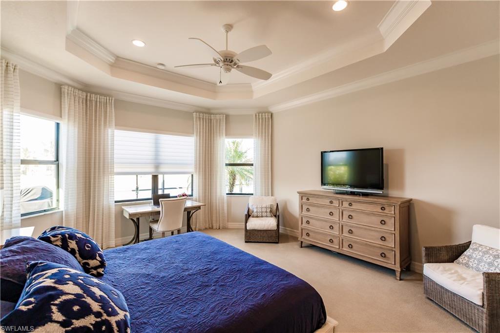 3432 Atlantic Circle Naples, FL 34119 - Photo 23 of 31 a bedroom with a bed and a flat screen tv
