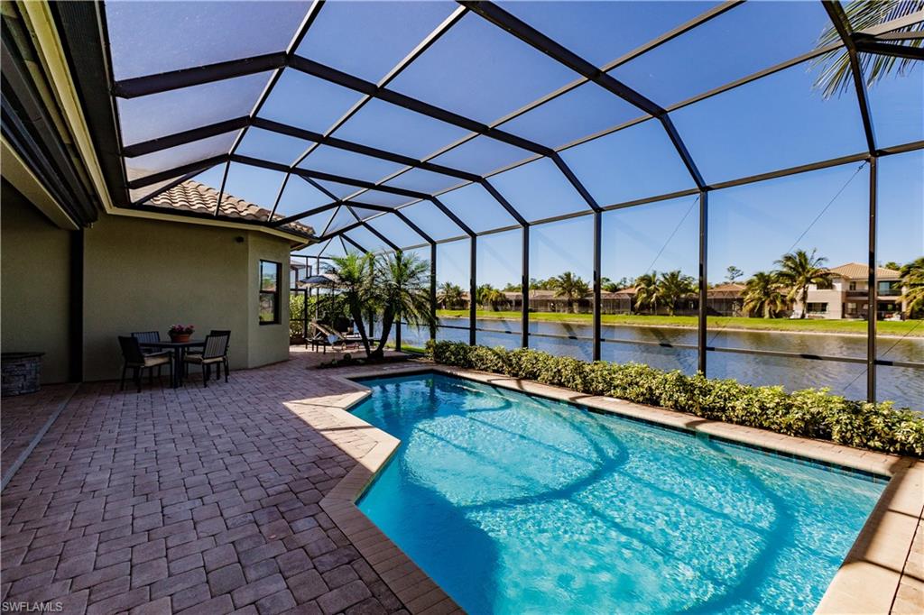 3432 Atlantic Circle Naples, FL 34119 - Photo 26 of 31 a view of a swimming pool with a patio