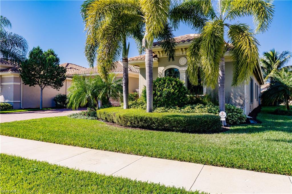 3432 Atlantic Circle Naples, FL 34119 - Photo 3 of 31 a view of a yard with palm trees