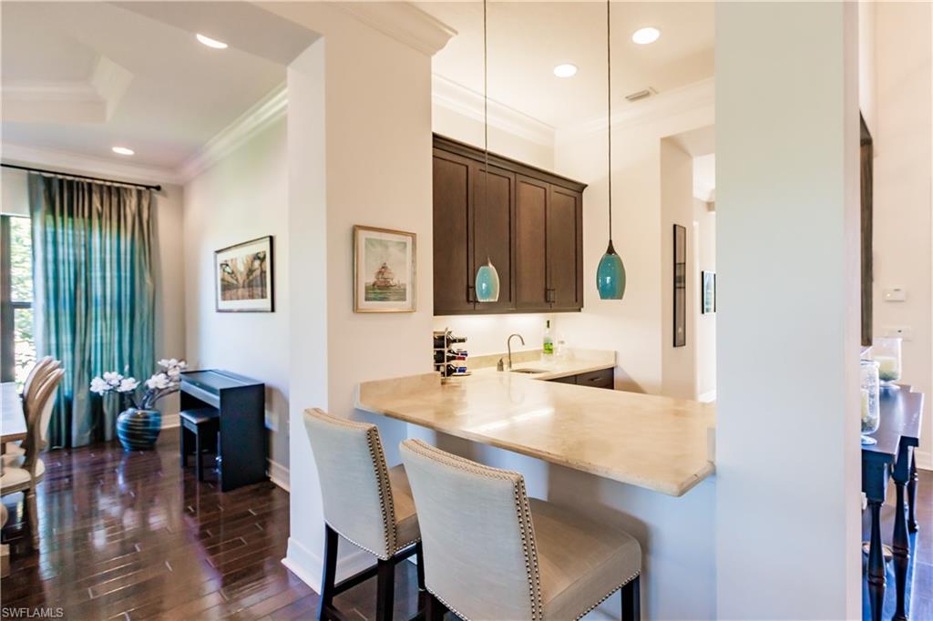 3432 Atlantic Circle Naples, FL 34119 - Photo 8 of 31 a view of a dining room with furniture and wooden floor