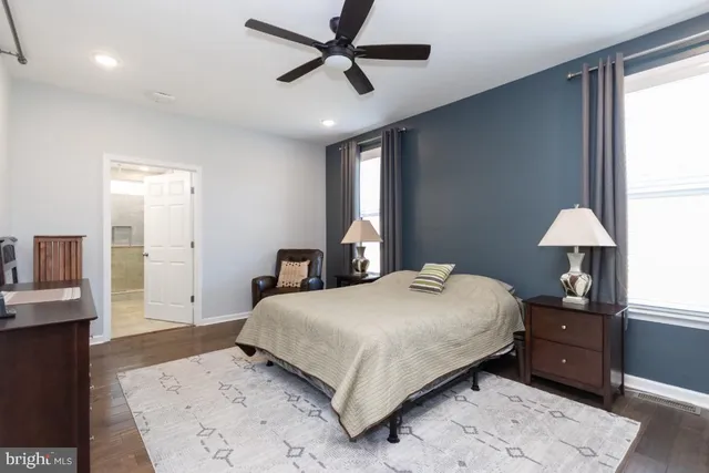 a bedroom with a large bed and a chandelier