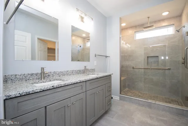 a bathroom with a granite countertop sink mirror and double