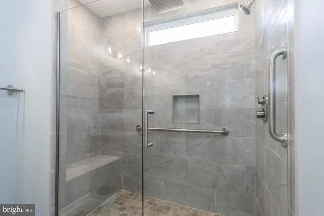 a bathroom with a glass shower door