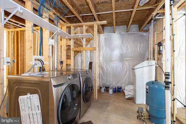 a view of a storage and utility room with washer and dryer