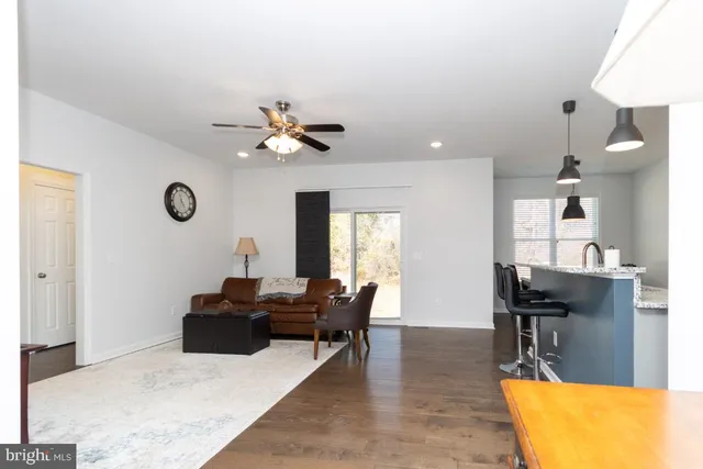 a living room with furniture a chandelier and a flat screen tv