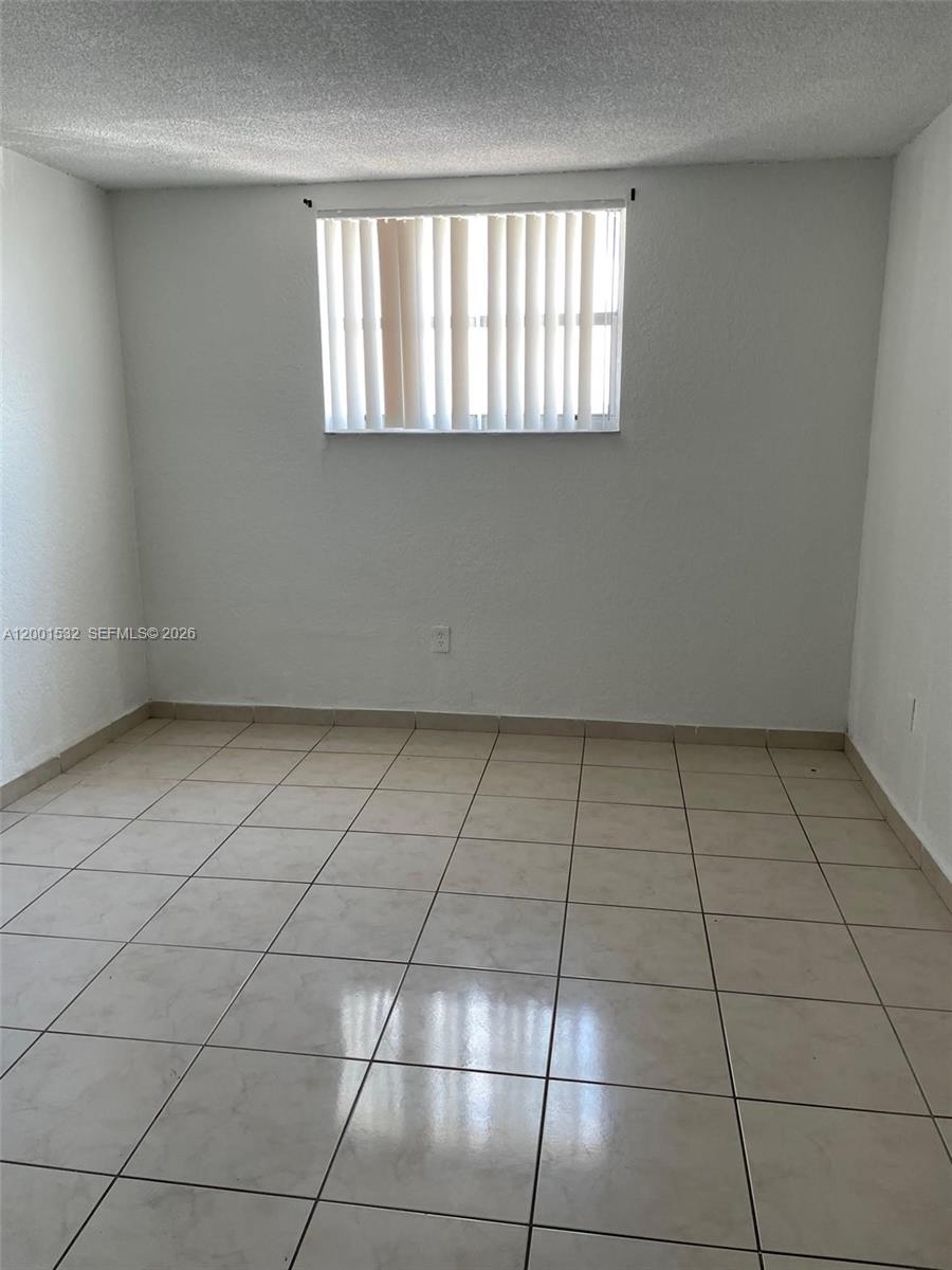 666 West 81st Street, Unit 407 Hialeah, FL 33014 - Photo 3 of 9 a view of an empty room and window