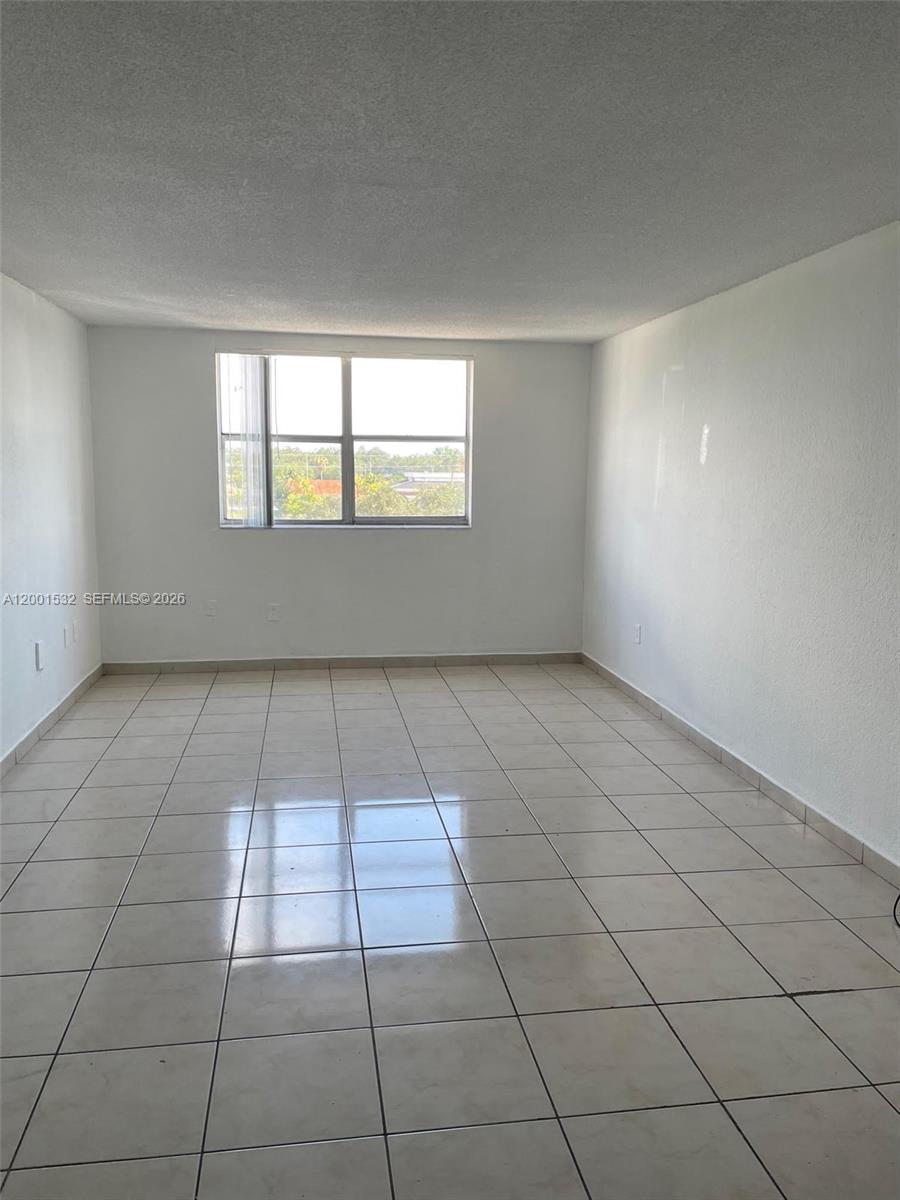 666 West 81st Street, Unit 407 Hialeah, FL 33014 - Photo 4 of 9 a view of an empty room and window