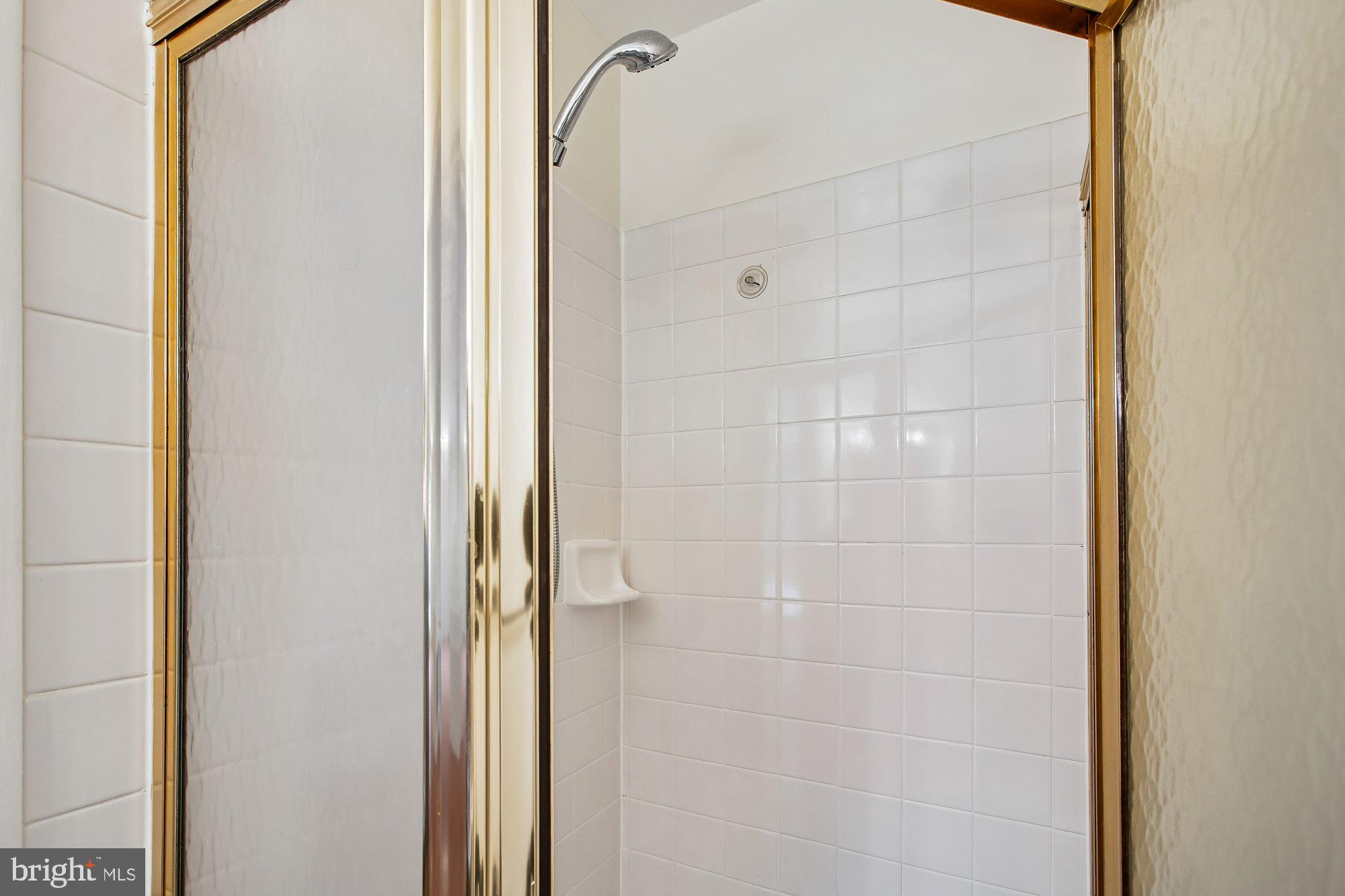 6621 Edsall Road Springfield, VA 22151 - Photo 11 of 42 a bathroom with a glass shower door