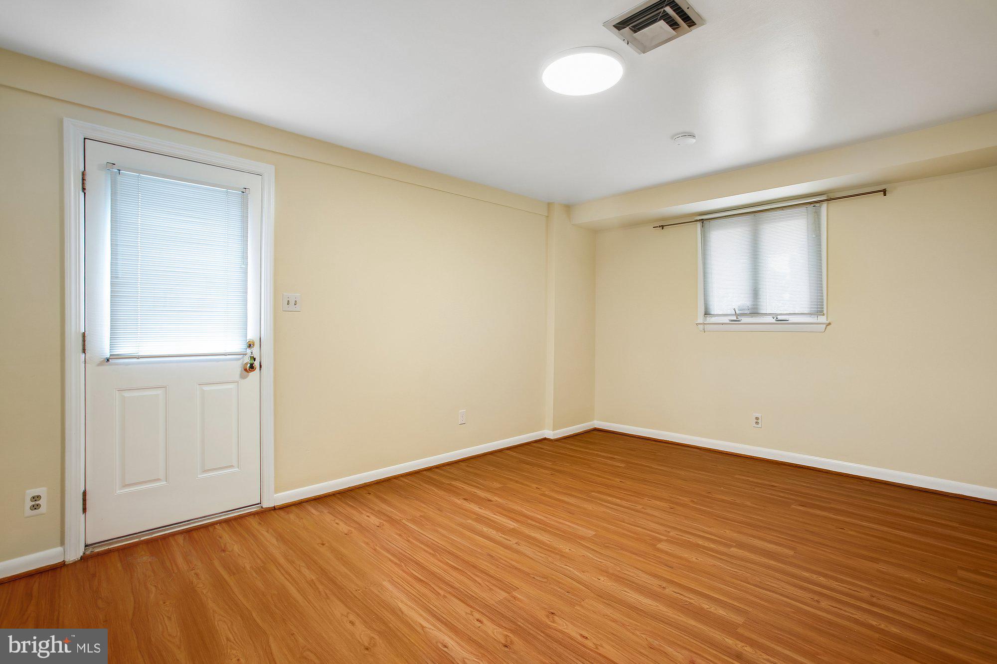 6621 Edsall Road Springfield, VA 22151 - Photo 12 of 42 an empty room with wooden floor and windows
