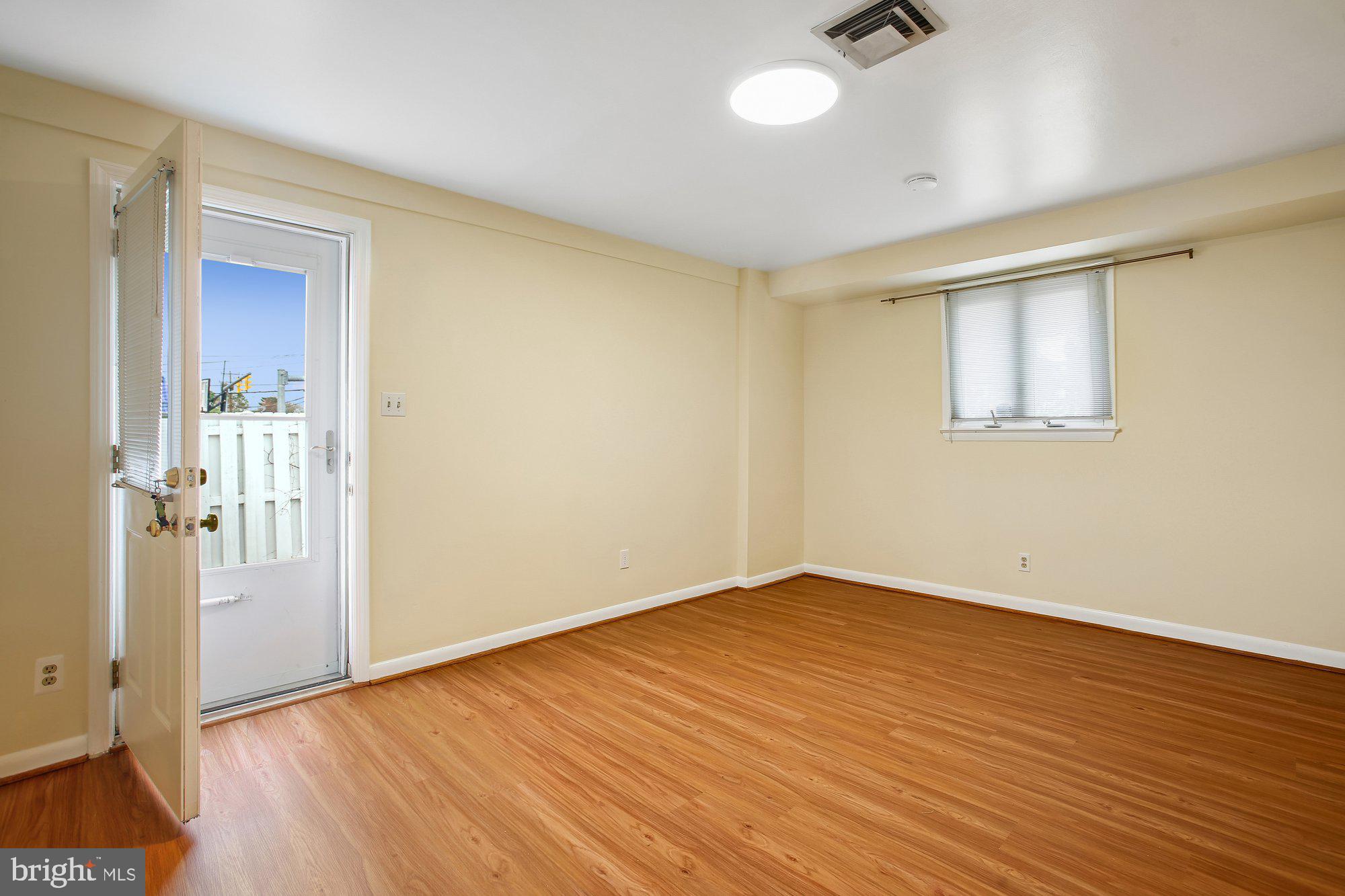 6621 Edsall Road Springfield, VA 22151 - Photo 13 of 42 an empty room with wooden floor and windows