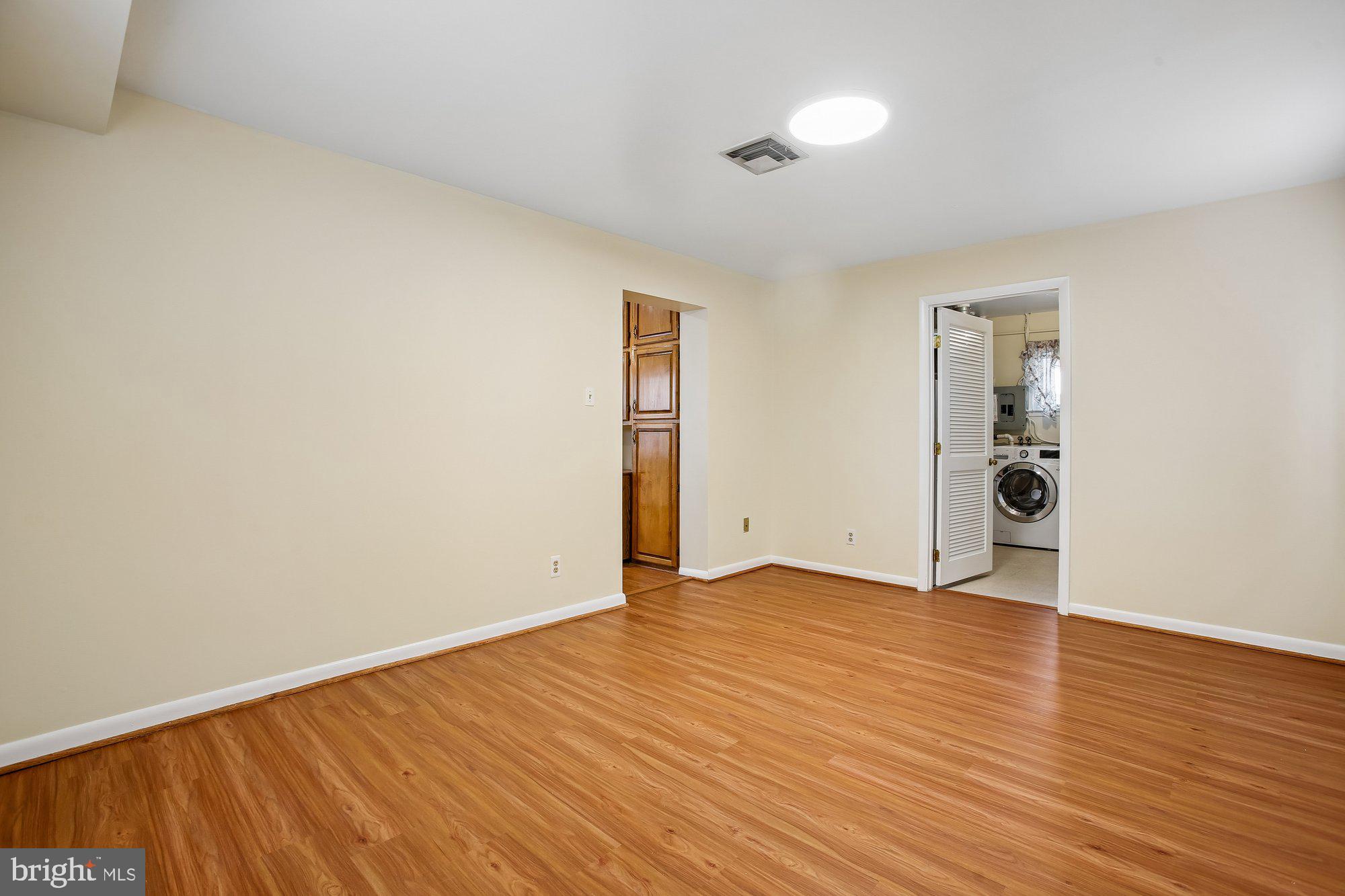 6621 Edsall Road Springfield, VA 22151 - Photo 14 of 42 an empty room with wooden floor and windows
