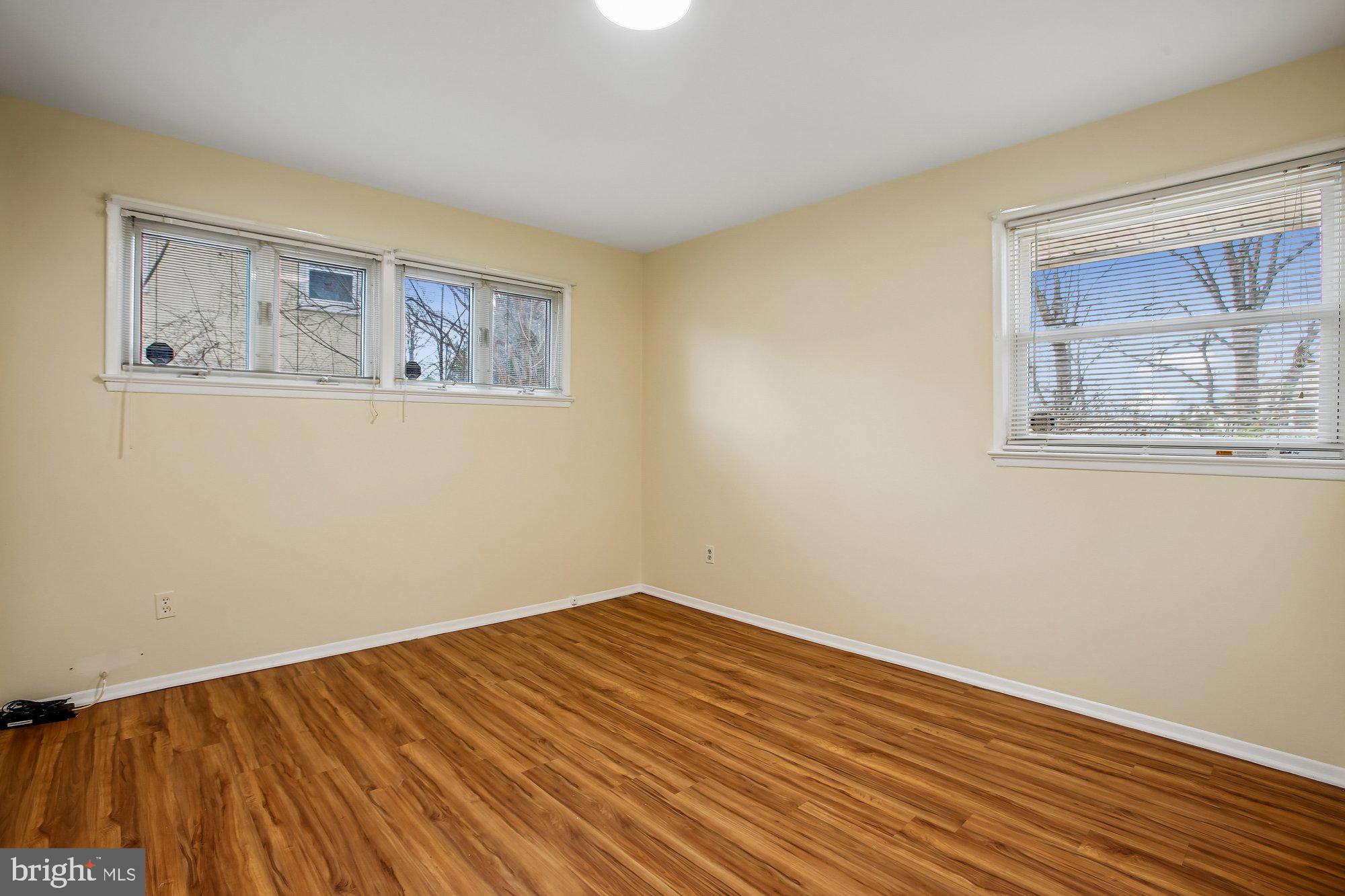 6621 Edsall Road Springfield, VA 22151 - Photo 18 of 42 a view of an empty room with wooden floor and a window