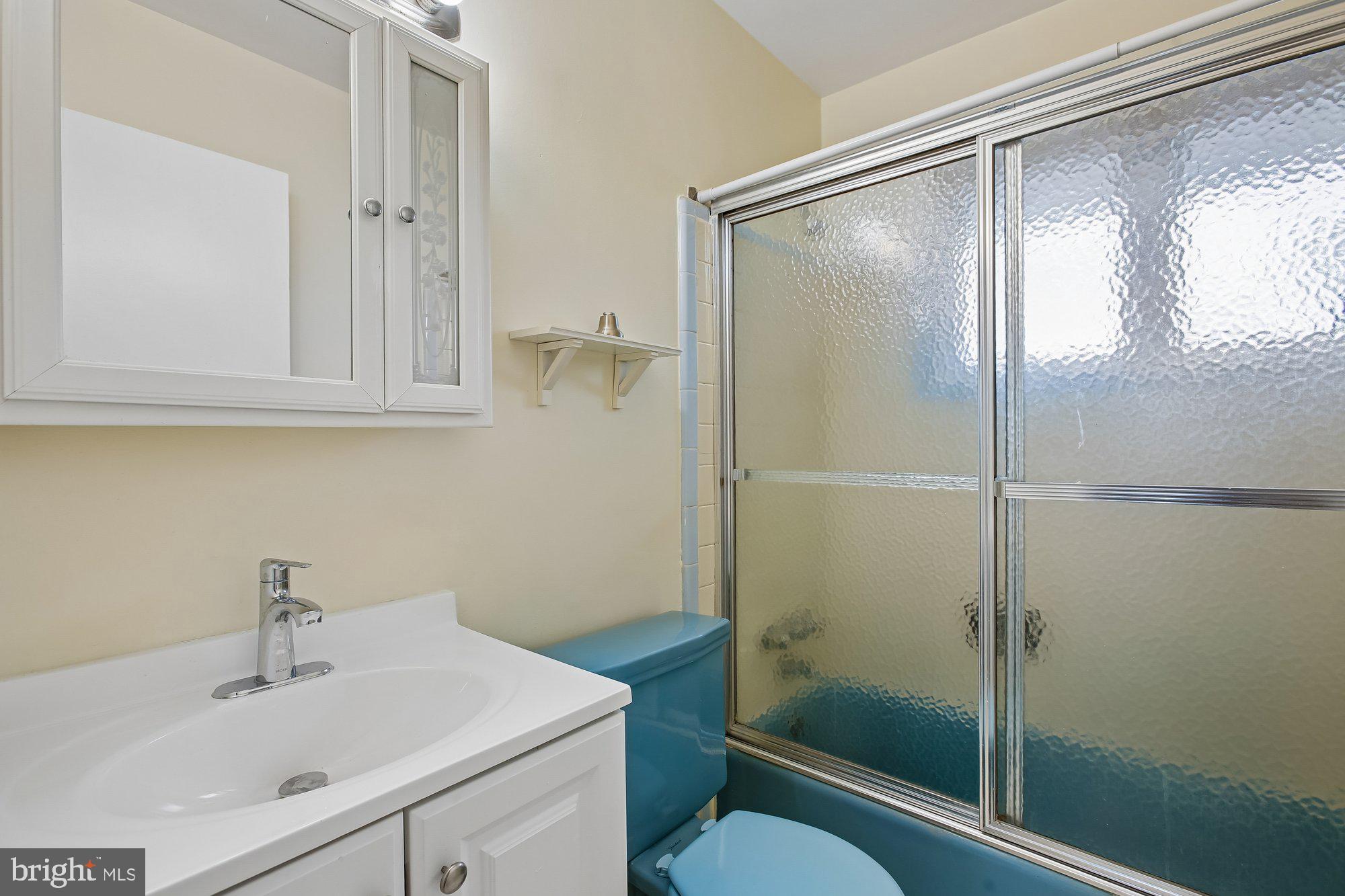 6621 Edsall Road Springfield, VA 22151 - Photo 24 of 42 a bathroom with a shower sink vanity mirror and toilet