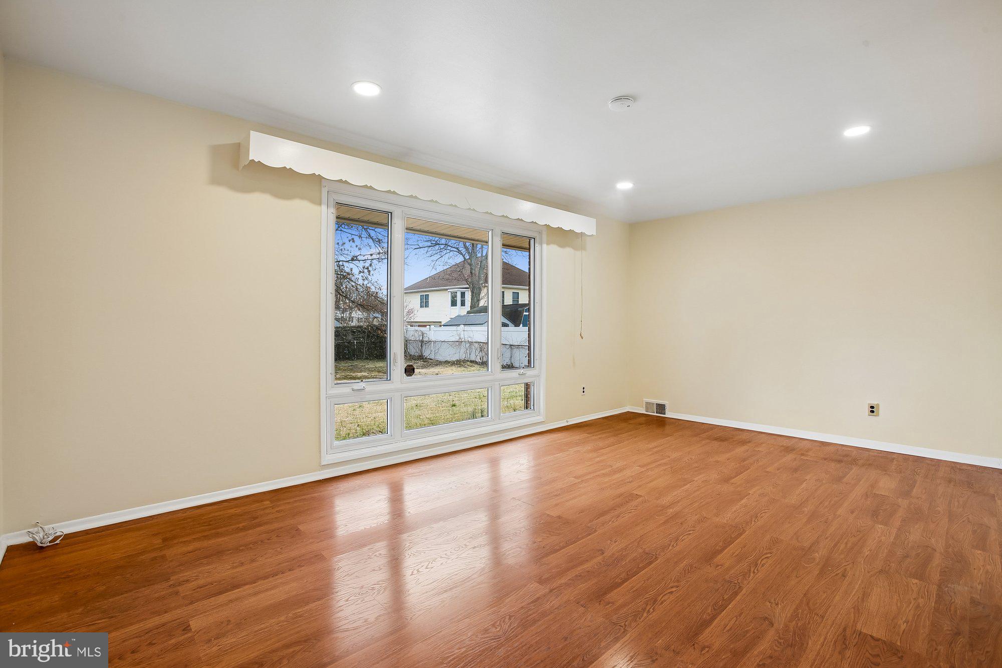 6621 Edsall Road Springfield, VA 22151 - Photo 3 of 42 an empty room with wooden floor and windows