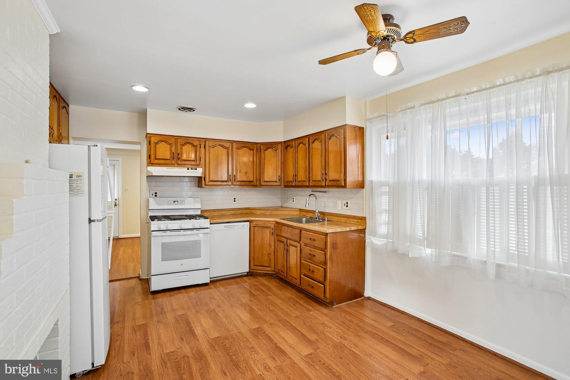 6621 Edsall Road Springfield, VA 22151 - Photo 7 of 42 a kitchen with stainless steel appliances granite countertop a refrigerator a stove a sink and a microwave