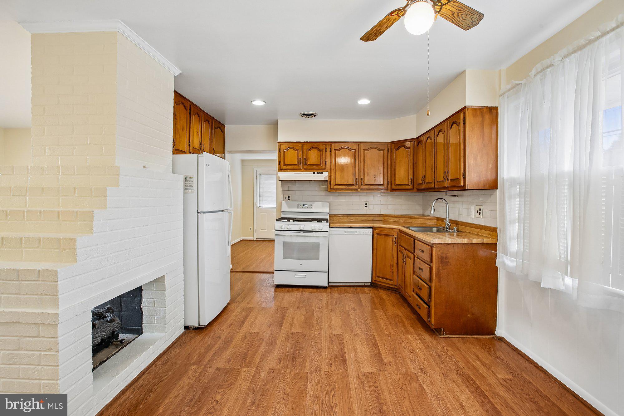 6621 Edsall Road Springfield, VA 22151 - Photo 8 of 42 a kitchen with white cabinets and stainless steel appliances