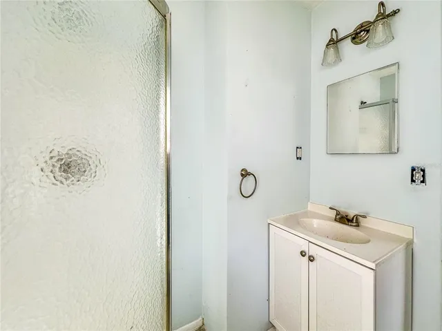 an empty room with a window and a ceiling fan