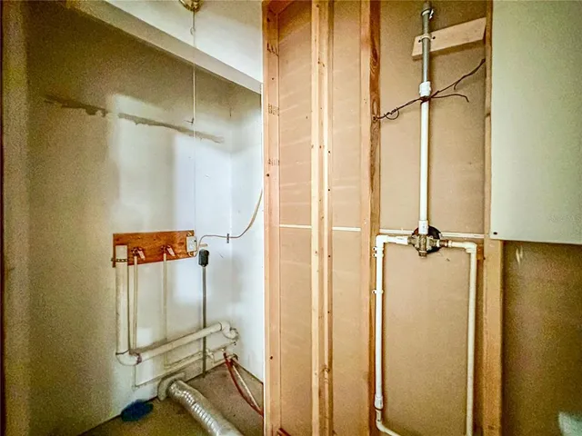 a bedroom with a bed and a large window with outer view