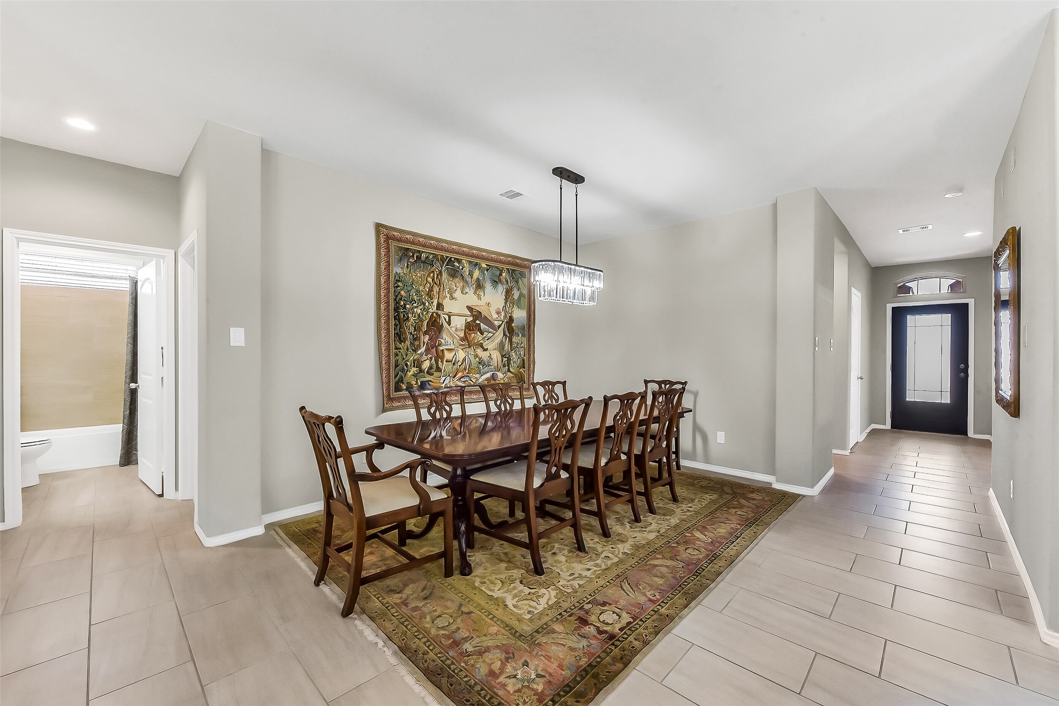24407 Hollow Gate Meadow Court Spring, TX 77389 - Photo 11 of 39 a view of a dining room and livingroom with furniture wooden floor a chandelier