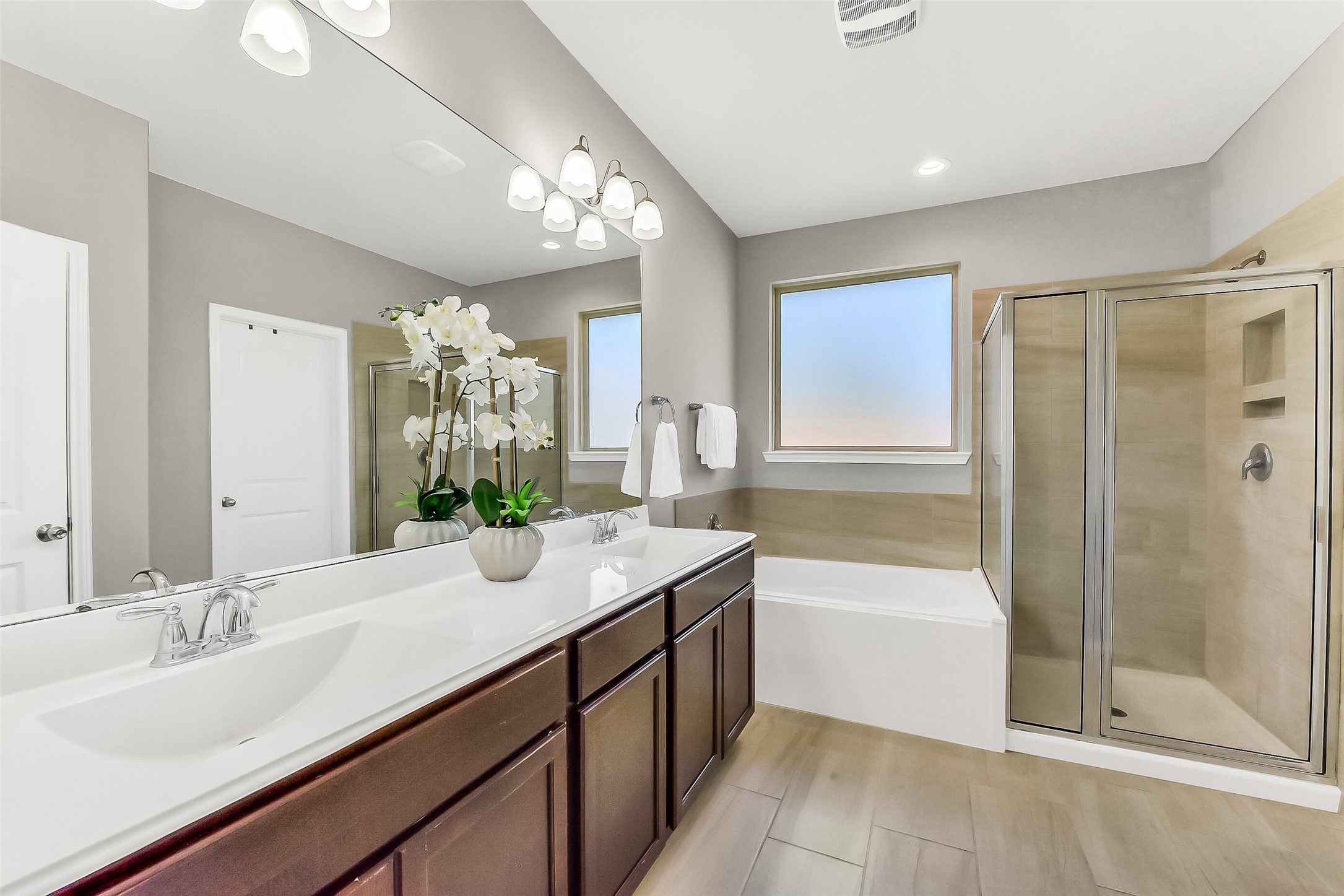 24407 Hollow Gate Meadow Court Spring, TX 77389 - Photo 20 of 39 a bathroom with a granite countertop sink a mirror a bathtub and next to a window