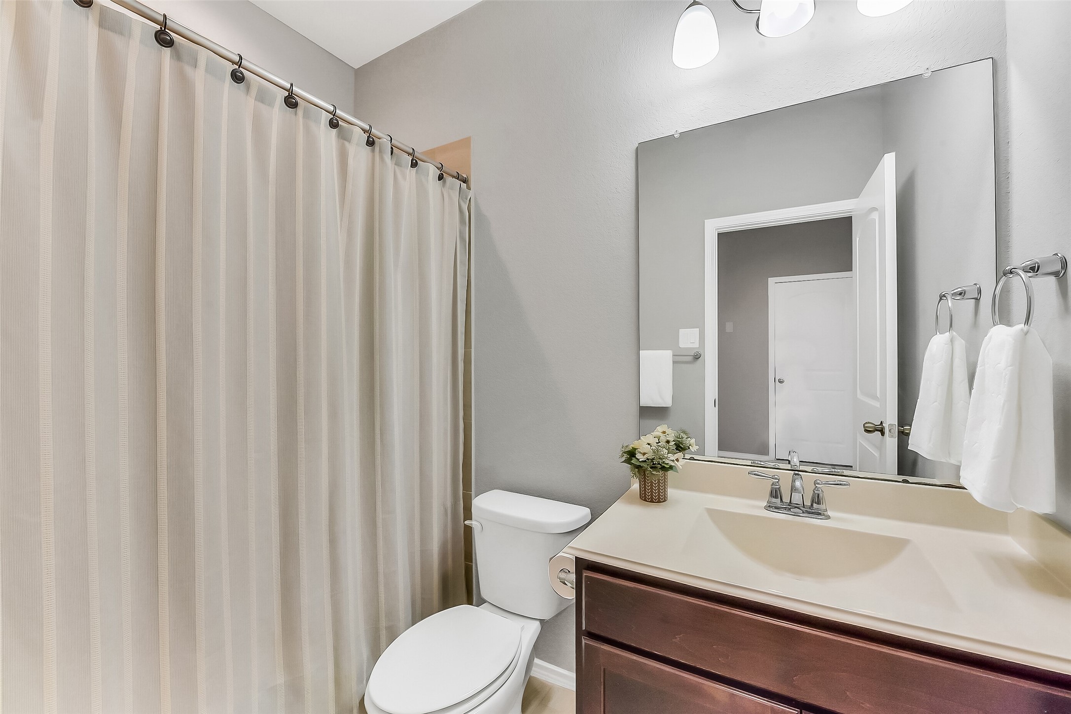 24407 Hollow Gate Meadow Court Spring, TX 77389 - Photo 25 of 39 a bathroom with a sink a toilet and shower curtain