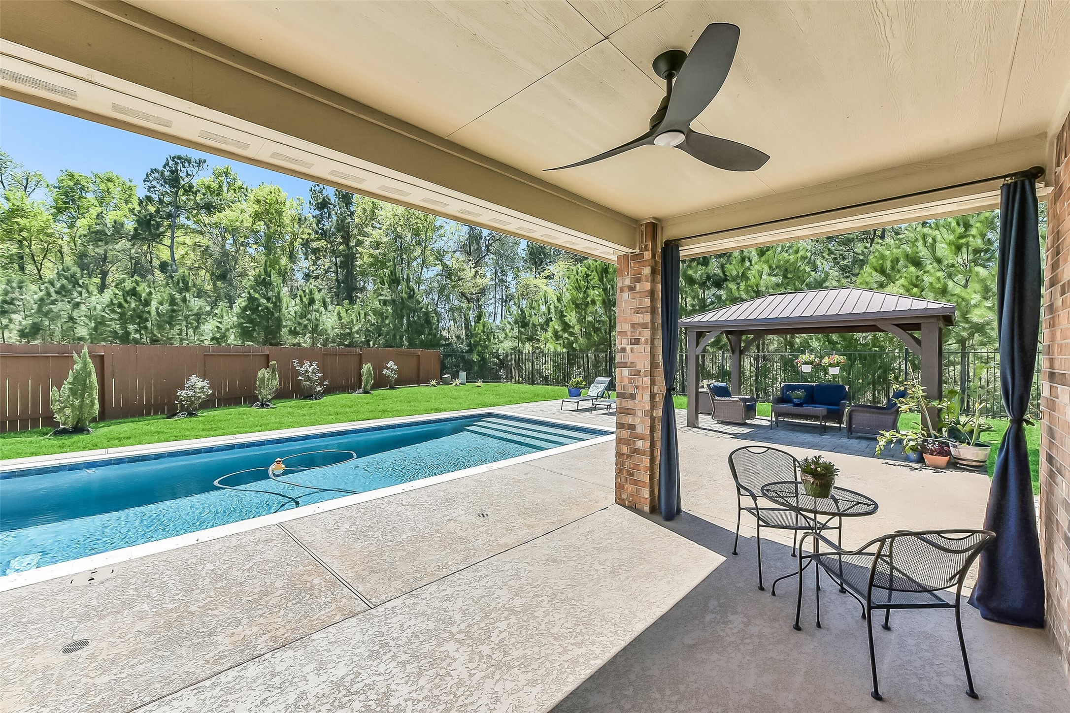 24407 Hollow Gate Meadow Court Spring, TX 77389 - Photo 29 of 39 a living room with a floor to ceiling window and a table