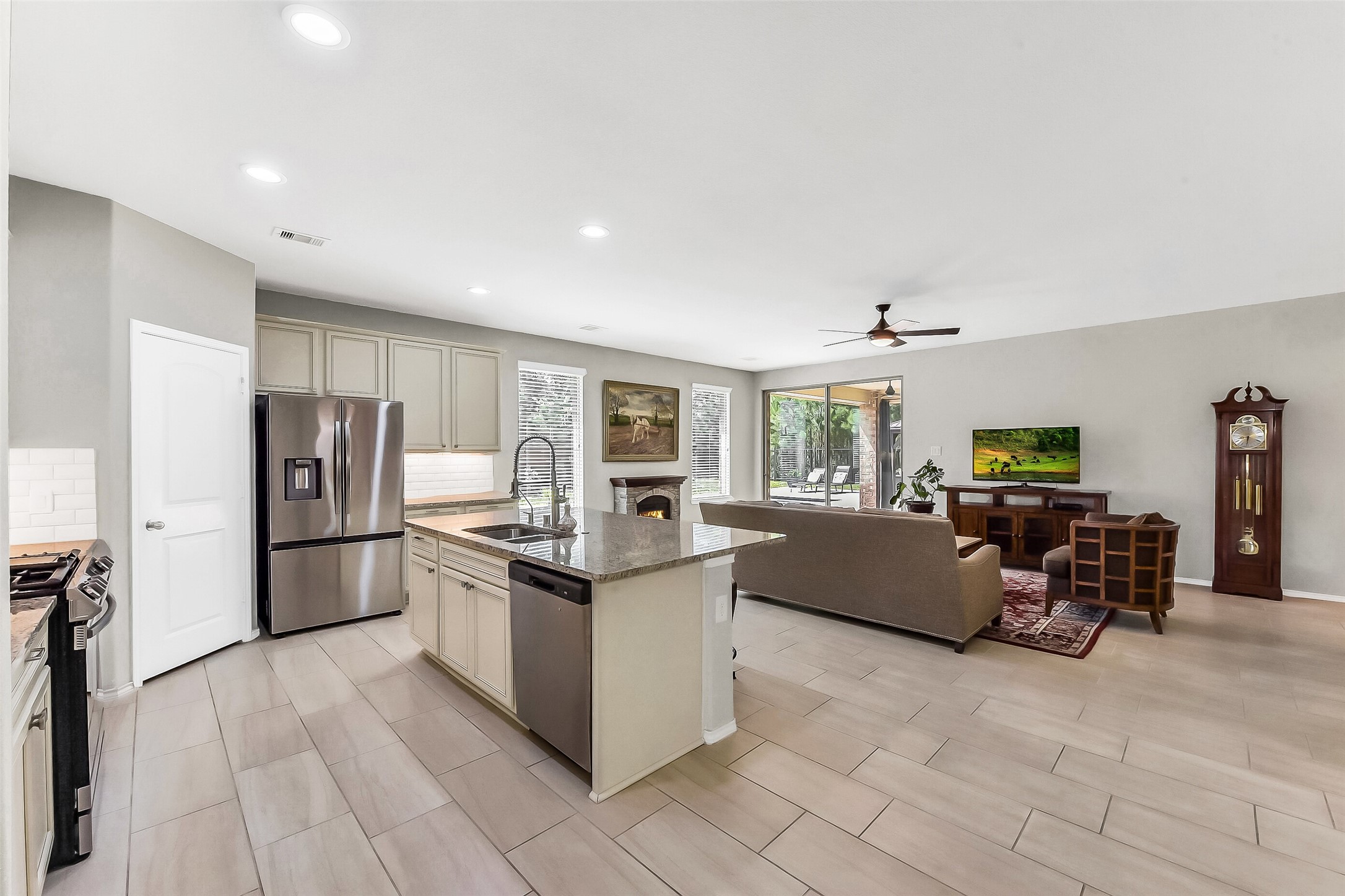 24407 Hollow Gate Meadow Court Spring, TX 77389 - Photo 5 of 39 a kitchen with stainless steel appliances granite countertop a refrigerator and a stove top oven