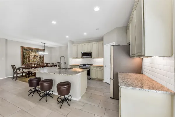 a view of a dining room and livingroom with furniture wooden floor a chandelier