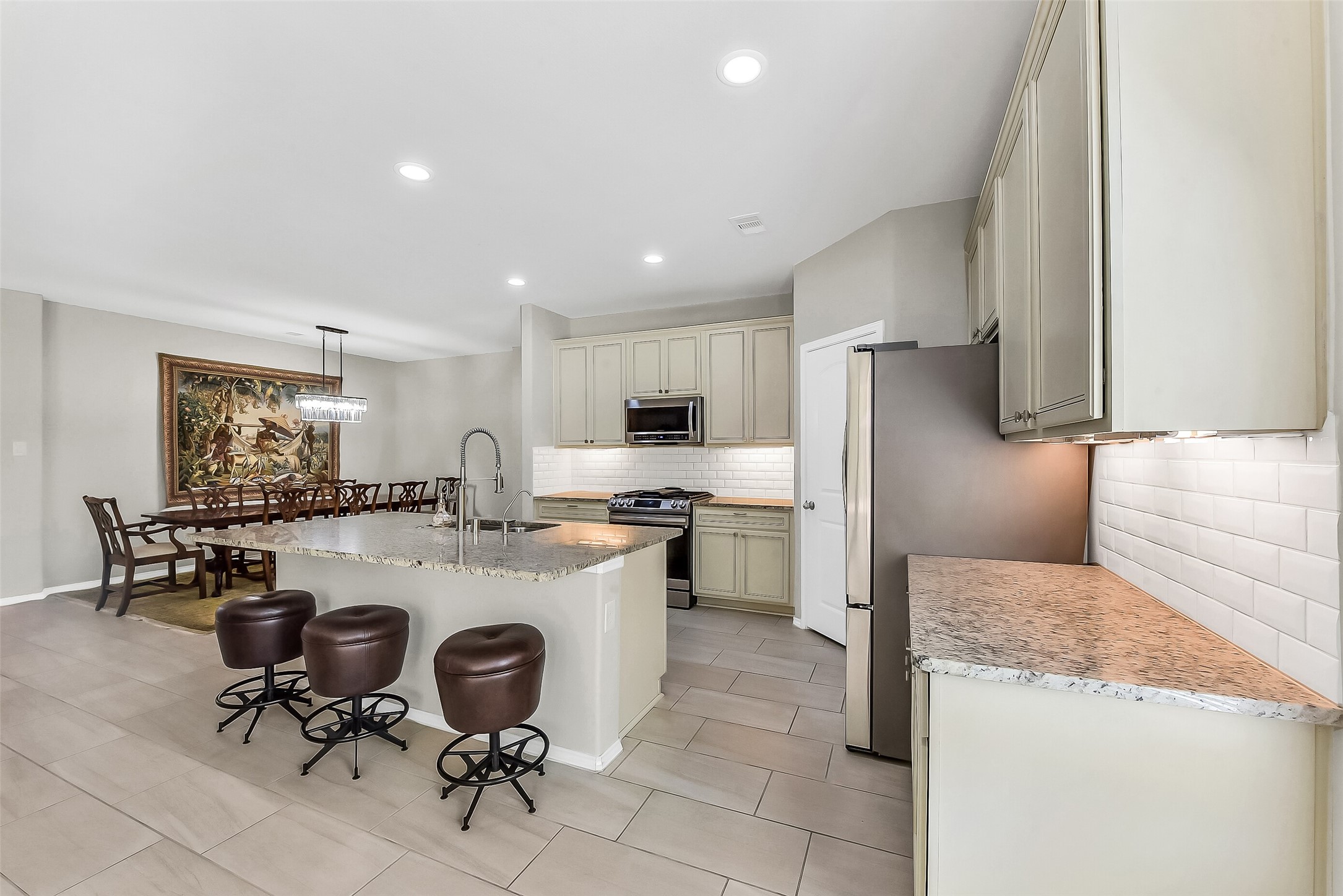24407 Hollow Gate Meadow Court Spring, TX 77389 - Photo 8 of 39 a kitchen with refrigerator and chairs