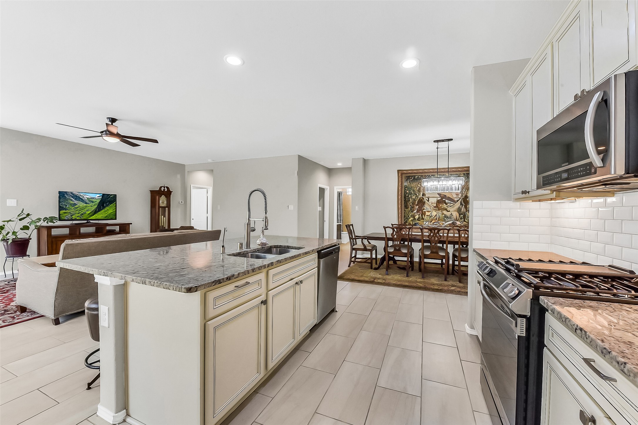 24407 Hollow Gate Meadow Court Spring, TX 77389 - Photo 10 of 39 a kitchen with stainless steel appliances granite countertop a stove and a sink