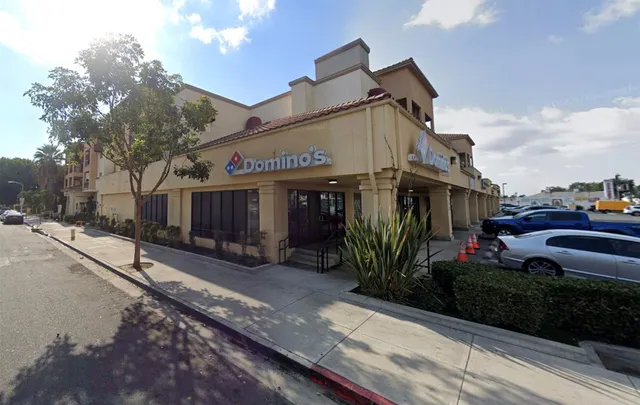 a view of a house with many windows next to a road