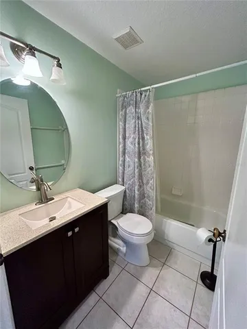a bathroom with a double vanity sink toilet and shower