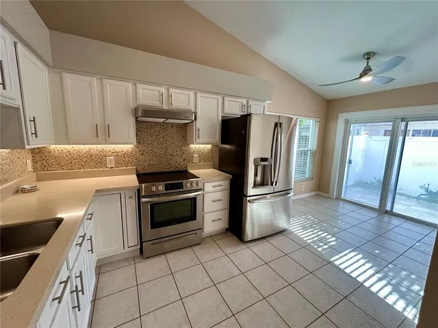 a kitchen with a stove a refrigerator and a sink