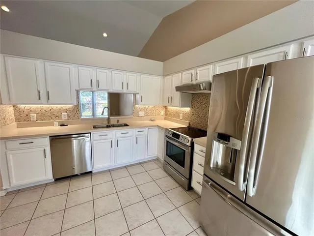 a kitchen with granite countertop cabinets and steel stainless steel appliances