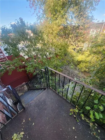 a balcony with trees in front of it